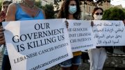 Demonstrators carry placards during a gathering by cancer patients to protest against a shortage of medicines in Beirut on August 26, 2021 (AFP)